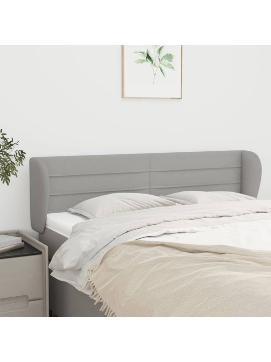 Čelo postele typu ušák světle šedé 147x23x78/88 cm textil