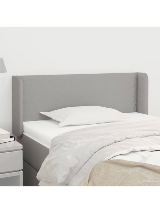 Čelo postele typu ušák světle šedé 83x16x78/88 cm textil