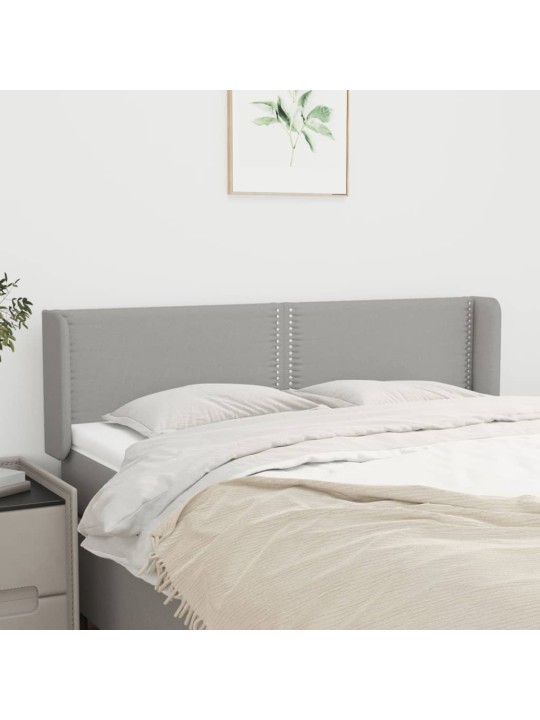 Čelo postele typu ušák světle šedé 147x16x78/88 cm textil