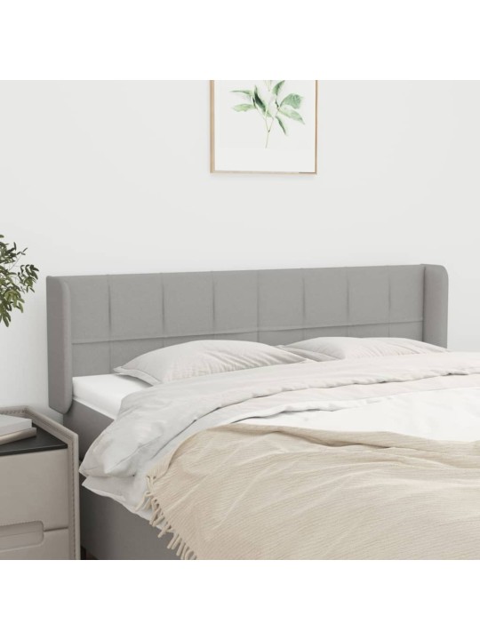 Čelo postele typu ušák světle šedé 147x16x78/88 cm textil