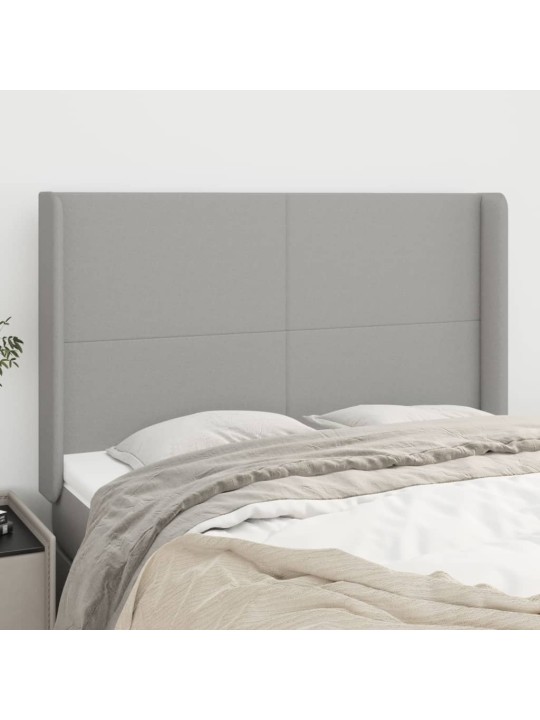 Čelo postele typu ušák světle šedé 147x16x118/128 cm textil