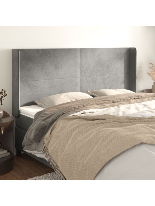 Čelo postele typu ušák světle šedé 163x16x118/128 cm samet