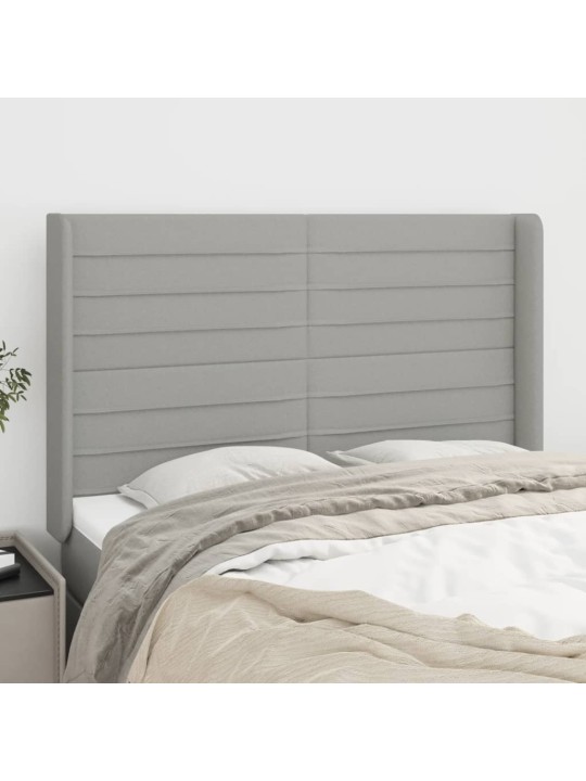Čelo postele typu ušák světle šedé 147x16x118/128 cm textil