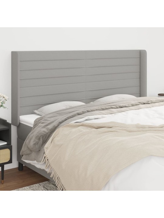 Čelo postele typu ušák světle šedé 163x16x118/128 cm textil
