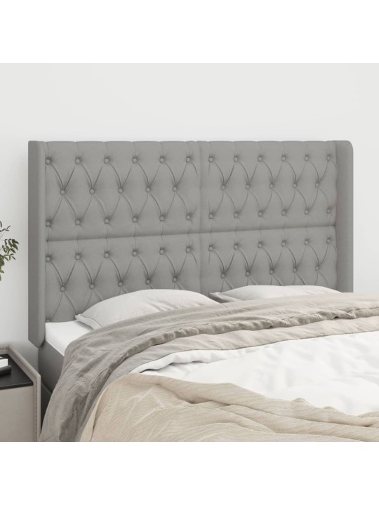 Čelo postele typu ušák světle šedé 163x16x118/128 cm textil