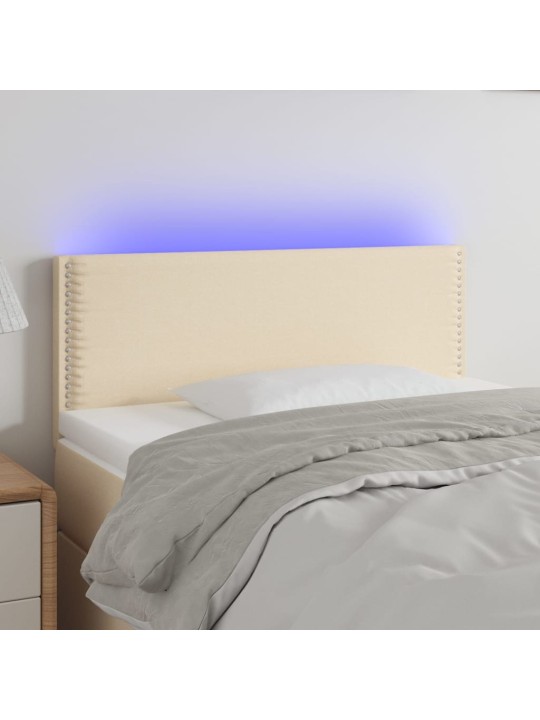 Čelo postele s LED krémové 100x5x78/88 cm textil