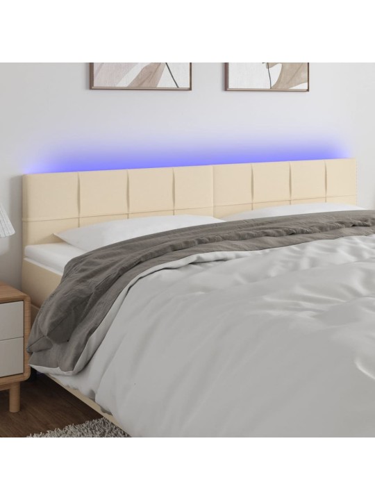 Čelo postele s led krémové 160x5x78/88 cm textil