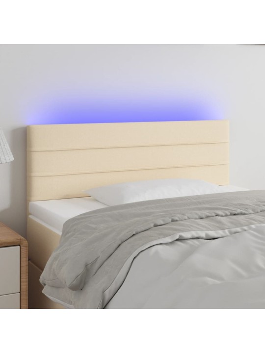Čelo postele s LED krémové 100x5x78/88 cm textil