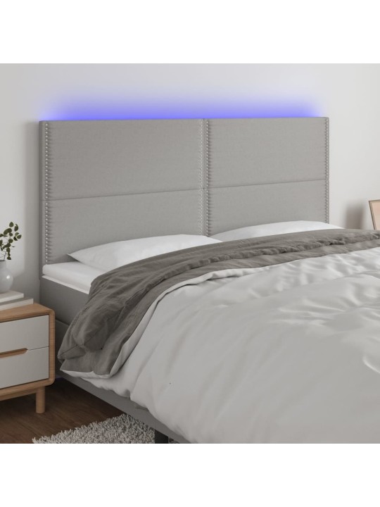 Čelo postele s LED světle šedé 160x5x118/128 cm textil