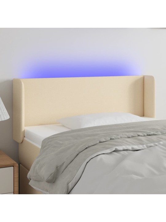 Čelo postele s LED krémové 83 x 16 x 78/88 cm textil