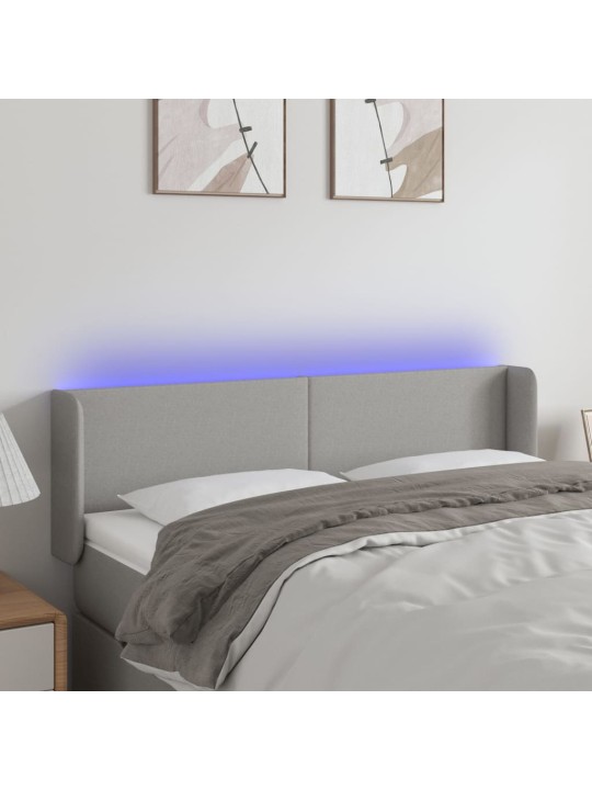 Čelo postele s LED světle šedé 147 x 16 x 78/88 cm textil