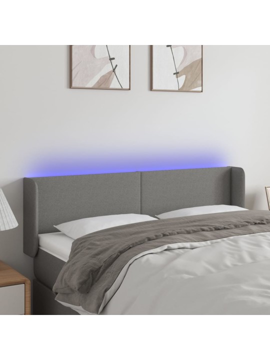 Čelo postele s LED tmavě šedé 147 x 16 x 78/88 cm textil