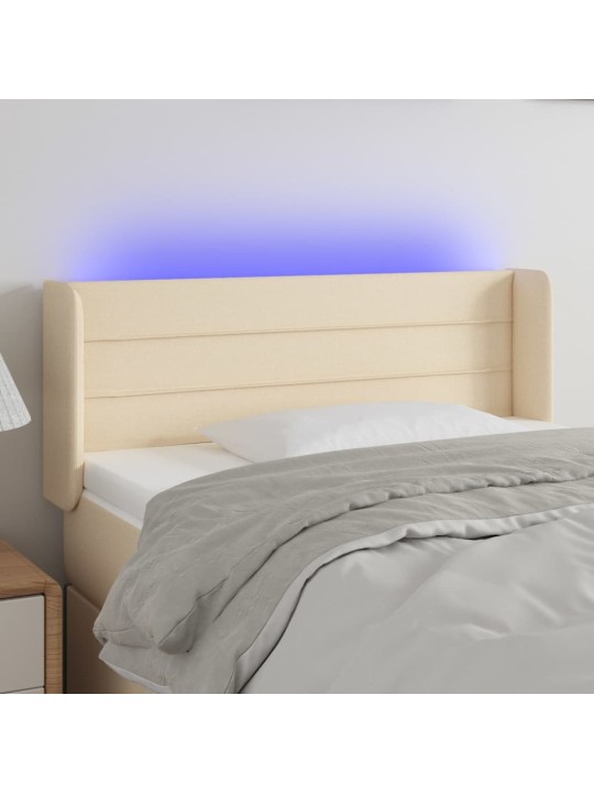 Čelo postele s LED krémové 83 x 16 x 78/88 cm textil