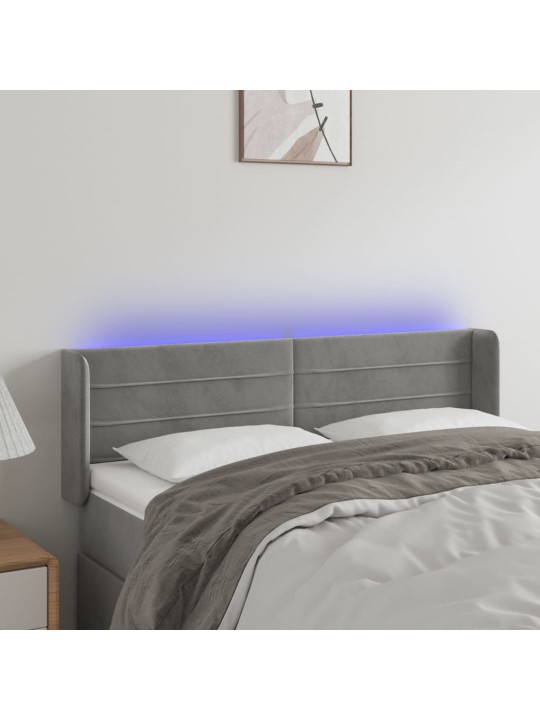 Čelo postele s LED světle šedé 147 x 16 x 78/88 cm samet