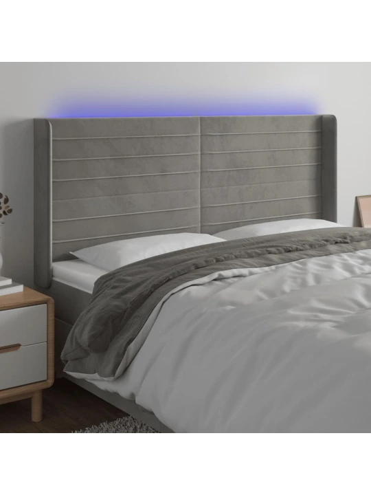 Čelo postele s LED světle šedé 163 x 16 x 118/128 cm samet